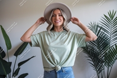 Woman wearing light green t shirt and hat t-shirt Product Image 1
