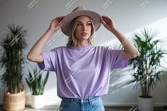 Woman wearing lavender t shirt and hat image Product Image 1