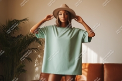 Woman wearing mint green t shirt and hat image Product Image 1