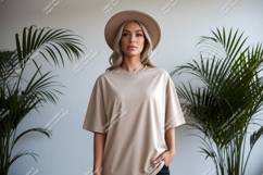 Woman wearing beige t-shirt and hat Product Image 1