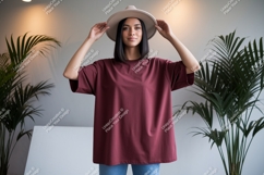 Woman wearing maroon t shirt and hat Product Image 1