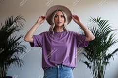 Woman wearing purple t shirt and hat image Product Image 1