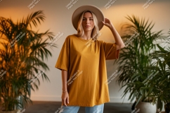Woman wearing mustard t shirt and hat image Product Image 1