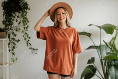 Woman wearing terracotta t-shirt and hat Product Image 1