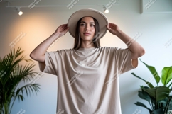 Woman wearing beige t shirt and hat t-shirt fashion Product Image 1
