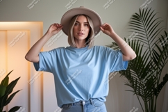 Blonde woman wearing blue t-shirt and hat Product Image 1