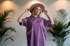Woman wearing purple t-shirt and hat plants Product Image 1