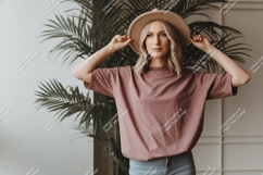 Woman wearing dusty rose t shirt and hat image Product Image 1