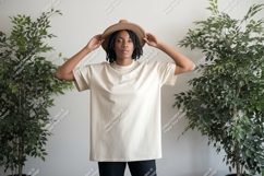 Woman wearing cream t shirt and hat image Product Image 1
