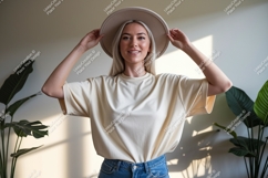 Woman wearing cream t shirt and hat image Product Image 1