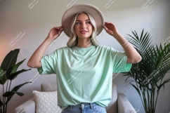 Woman wearing mint green t shirt and hat image Product Image 1