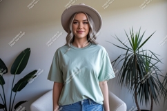 Woman wearing light green t-shirt and hat Product Image 1