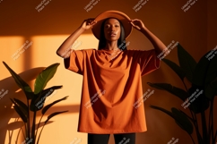 Woman wearing orange t shirt and hat image Product Image 1