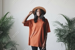 Woman wearing terracotta t-shirt and hat Product Image 1