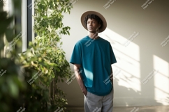 Man wearing teal t shirt and hat image Product Image 1