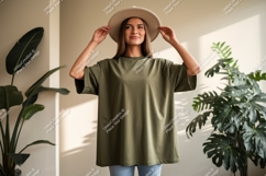 Woman wearing olive green t-shirt and hat Product Image 1