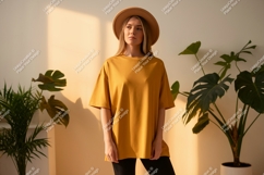 Woman wearing mustard yellow t shirt and hat image Product Image 1