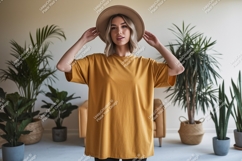 Woman wearing mustard t shirt and hat Product Image 1