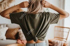 Woman tying shirt knot green denim Product Image 1