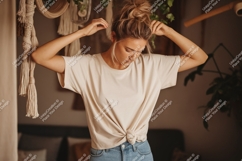 Woman wearing cream t shirt tied at waist Product Image 1