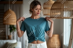 Woman wearing teal t shirt and white jeans image Product Image 1