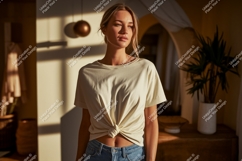 Woman wearing cream t shirt and jeans t-shirt tied Product Image 1
