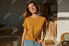 Woman wearing mustard t shirt and denim jeans image Product Image 1