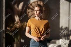 Woman wearing mustard yellow t shirt and denim jeans Product Image 1
