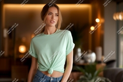 Woman wearing mint green t shirt and jeans image Product Image 1