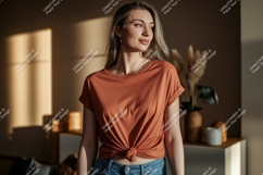Woman wearing rust colored t shirt jeans Product Image 1