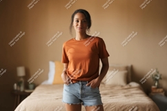 Woman wearing orange t shirt denim shorts image Product Image 1