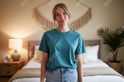 Woman wearing teal t shirt and denim jeans image Product Image 1