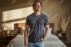 Man wearing charcoal t shirt and blue jeans image Product Image 1