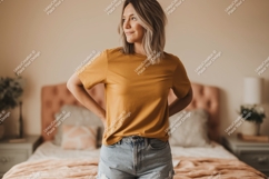 Woman wearing mustard t shirt and denim short Product Image 1