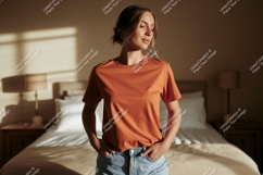 Woman wearing orange t shirt and jeans image Product Image 1