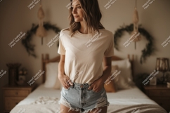 Woman wearing plain cream t shirt and denim shorts Product Image 1