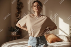 Woman wearing beige t shirt and denim shorts image Product Image 1