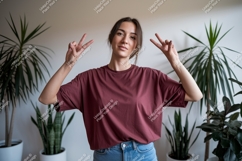 Woman wearing maroon t shirt and blue jeans image Product Image 1