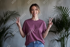 Woman wearing purple t shirt and jeans image Product Image 1