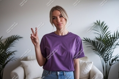 Woman wearing purple t shirt and jeans image Product Image 1