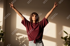 Woman wearing maroon t shirt and jeans image Product Image 1