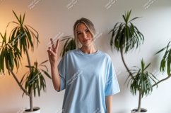Woman peace sign light blue shirt image Product Image 1