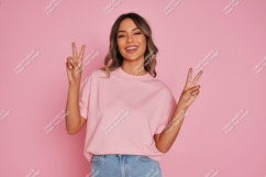 Woman peace sign pink shirt jeans Product Image 1