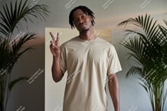 Man wearing tan t shirt peace sign image Product Image 1