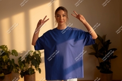 Young Woman Blue T Shirt Peace Gesture t-shirt Product Image 1