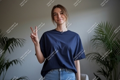 Woman wearing navy t shirt and jeans showing peace sign Product Image 1