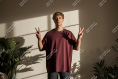 Young man wearing maroon t shirt gesturing peace t-shirt Product Image 1