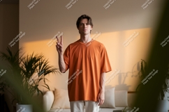 Man orange shirt peace gesture image Product Image 1