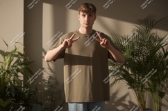 Man wearing olive green t-shirt making peace sign image Product Image 1