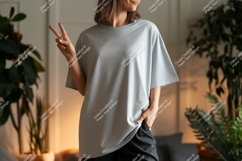 Woman wearing grey t shirt and black pants peace sign Product Image 1